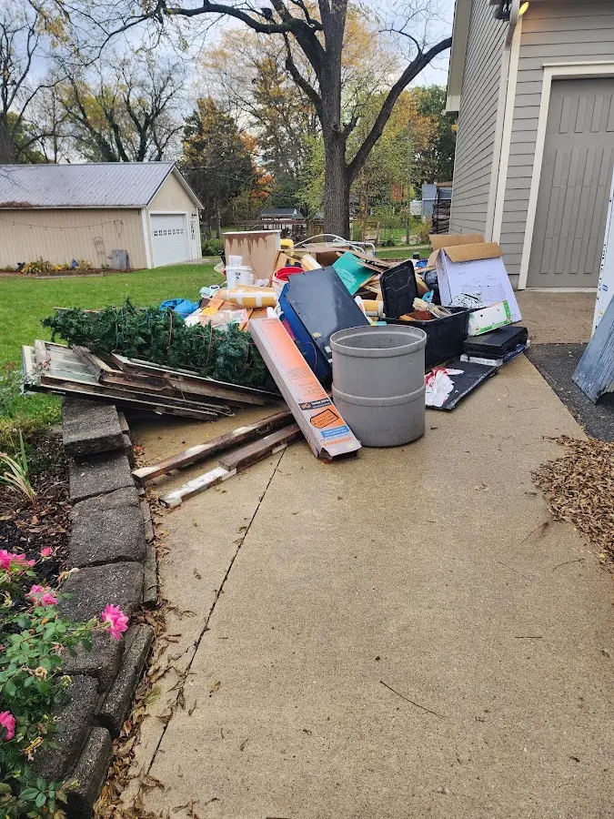 Dumpster being loaded with debris for Estate Cleanout Dumpster Rental in Haiku-Pauwela